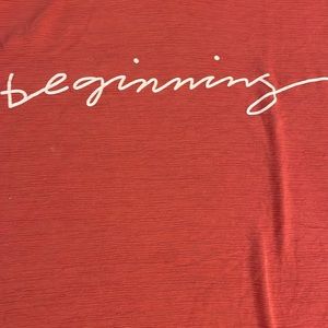 Fall Colored Blouse with White Cursive Writing Saying, “Beginning”